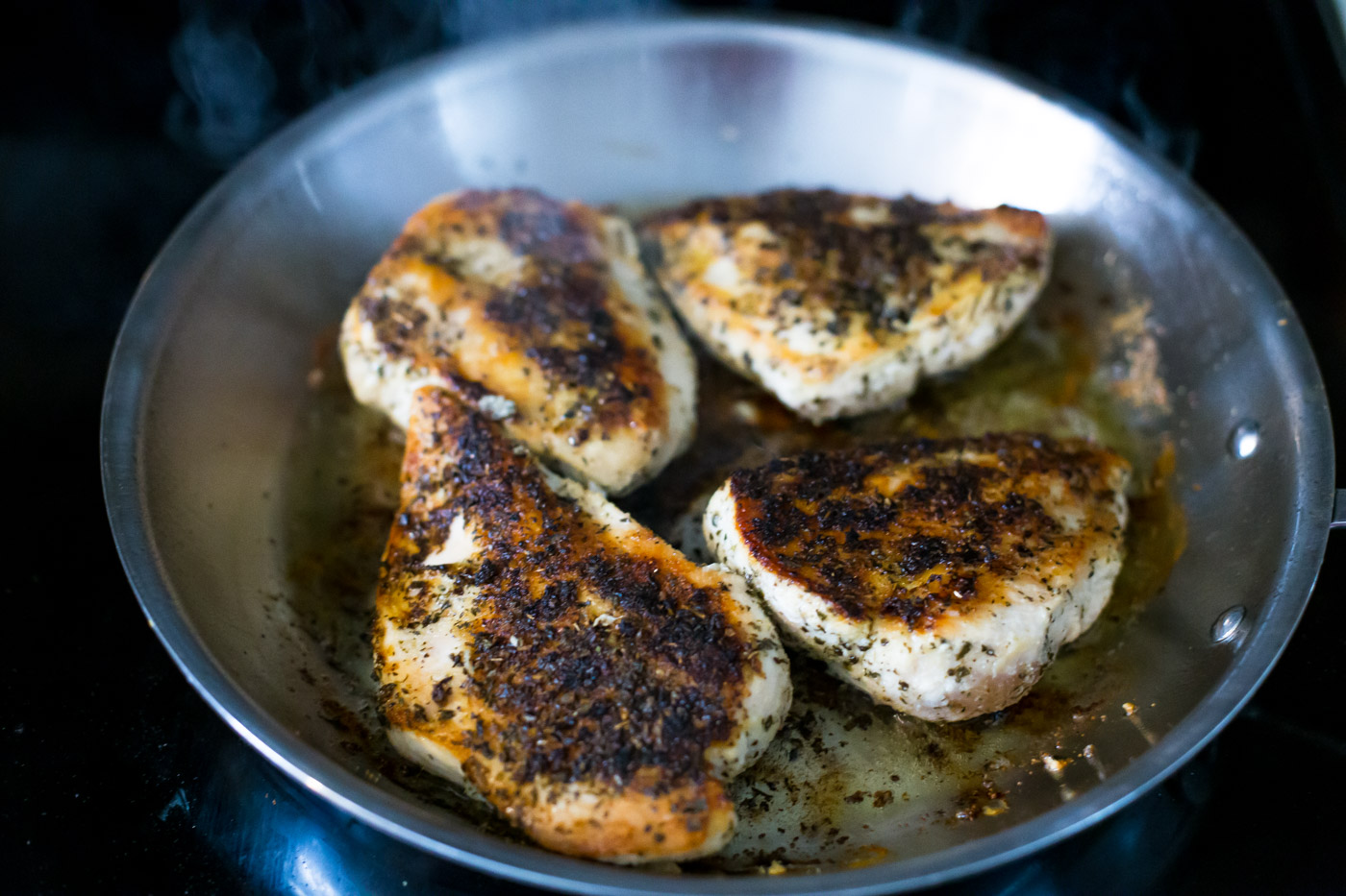 seasoned seared chicken breast in skillet