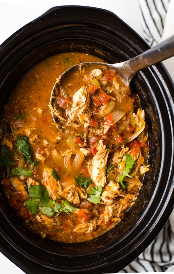 Chicken Tortilla Soup in black crock pot with ladle 