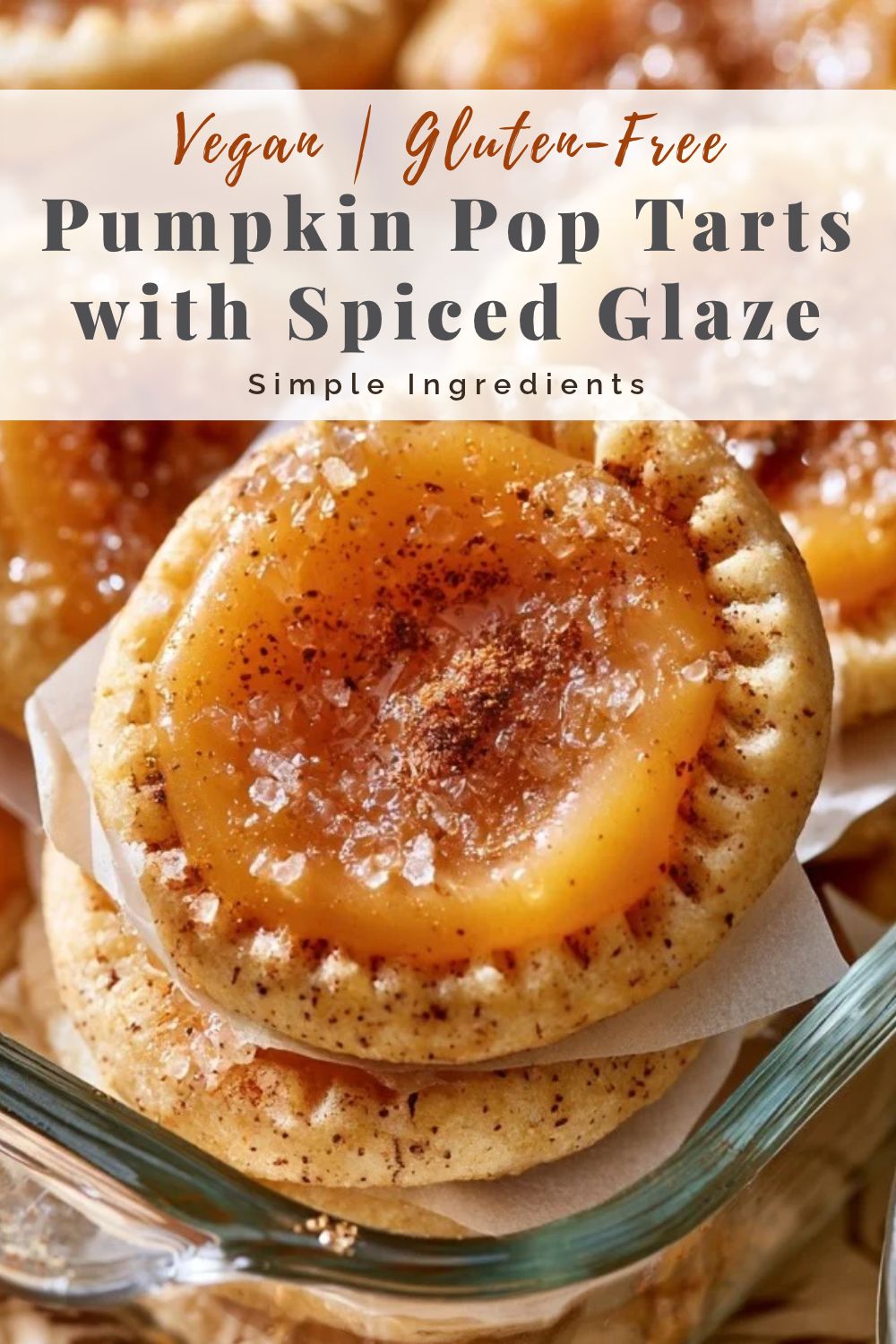 pinterest-ready image of glazed pumpkin pop tarts layered with parchment in a glass storage container